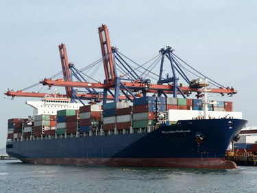 Wide-angle environmental shot of modern architectural port, massive container ships, cool crisp daylight, deep navy tones, 35mm