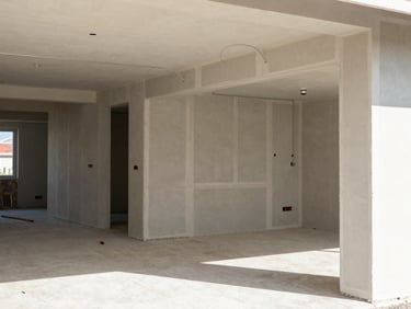 Bright natural daylight illuminating a modern commercial interior fit-out under construction, exposed wiring and drywalls.