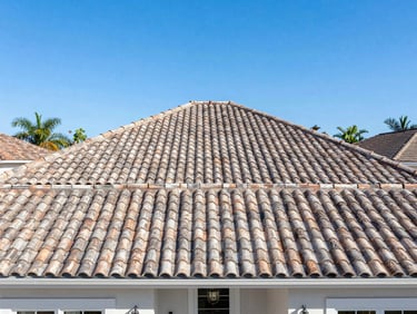 Wide-angle hero shot of a beautiful Florida home with a pristine tile roof, bright direct sunlight, crisp details, 35mm lens