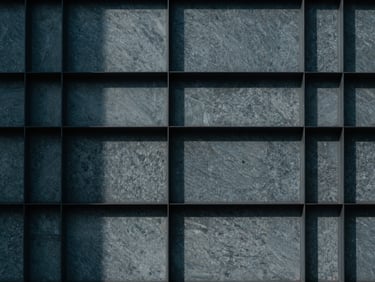 Minimalist abstract texture of structured steel and stone, cool overcast daylight, sharp shadows, editorial architectural photography
