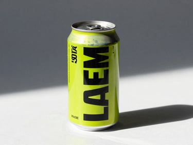 Dramatic studio lighting on premium beverage cans with bold typography, hard shadows, high-contrast