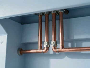 Close-up of newly installed copper pipes in a perfectly organized mechanical room, sharp focus, clean architectural photography, cool blue tones.