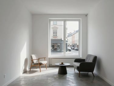 Open-plan studio apartment interior, compact but well-lit, white walls, large window facing street, minimalist furniture arrangement