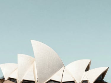 Minimalist architectural detail of the Sydney Opera House sails against a clear pale sky, high-key lighting, clean lines