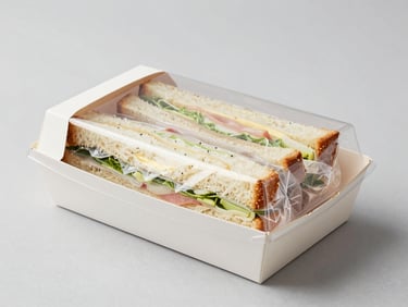 Clean modern food packaging box with transparent window showing a neatly wrapped sandwich, sterile environment, studio lighting.