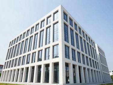 Wide-angle architectural exterior of a modern commercial office building, clean structural lines, bright daylight