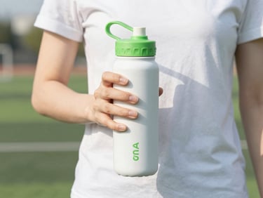 Active professional in motion, bright natural morning light, holding a sleek water bottle, clean white and vibrant green tones, shallow depth of field