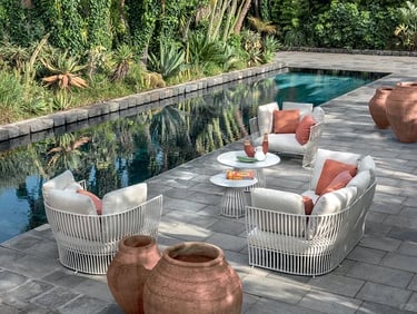Outdoor seating area with weather-resistant furniture, natural stone, woven textures and performance