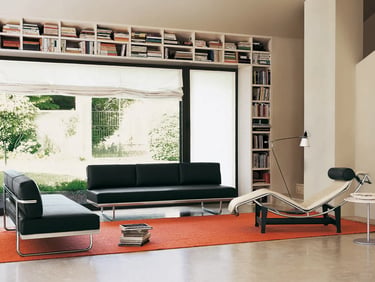 Calm modern living room with low seating, chaise longue, bookshelves and garden view inspired by Cha