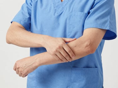 Close-up of a healthcare professional in medical blue scrubs, demonstrating fluid arm movement, showing the ergonomic fit and stretch of the fabric. Bright clinical studio light, sharp focus.