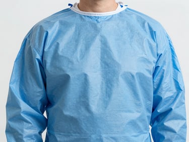 Close-up commercial photography of a medical barrier gown fabric, showing fluid-resistant texture, bright clinical studio light, sharp focus, medical blue tone