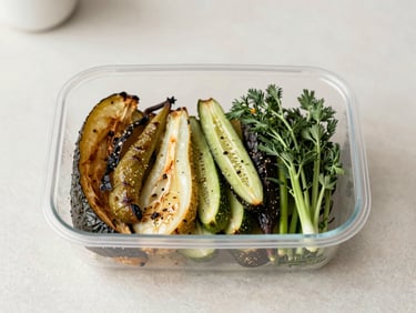 Overhead flatlay of roasted seasonal vegetables and herbs in a clean kitchen container, soft natural light