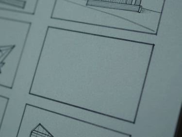 Extreme close-up of a storyboard sketch showing a cinematic frame layout, low-saturation tones.