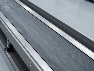 Overhead clean view of a modern passenger conveyor belt with non-slip gray textured surface, architectural alignment, cool studio lighting