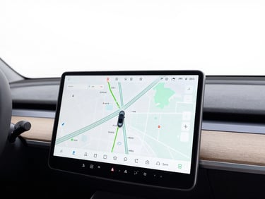 Close-up of a modern car dashboard screen displaying a map, clean interior, bright lighting, sharp focus.