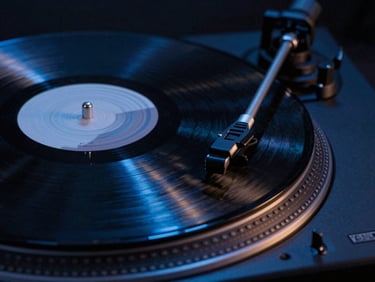 Tight macro shot of a spinning vinyl record on a turntable, moody low-key studio lighting, electric blue reflection
