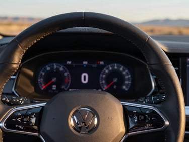 Macro detail of a modern Volkswagen steering wheel with digital cockpit instrumentation, sharp technical lighting, premium feel.