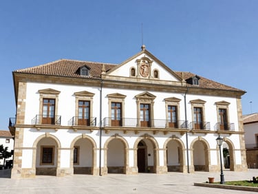 Bright outdoor daytime photo of the historic Guadarrama town hall building, clear blue sky, crisp natural daylight, 35mm lens