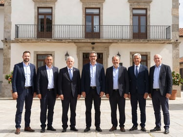 Bright environmental photo of the Guadarrama local government team standing together outside the town hall, smiling, natural daylight, professional setting