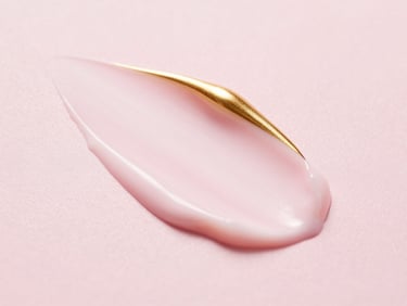 Close-up of Pond's bright beauty cream texture on a pink surface, soft lighting, elegant composition
