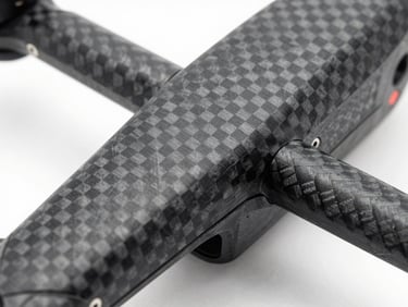 Extreme macro close-up of a 3D-printed carbon fiber drone arm, showing clean layer lines and high-contrast studio lighting.