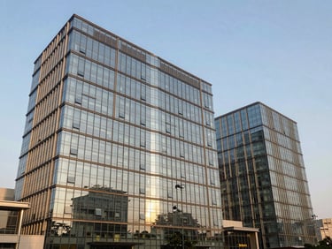 Modern glass office building facade on Dwarka Expressway Gurugram, bright natural daylight, sharp architectural focus
