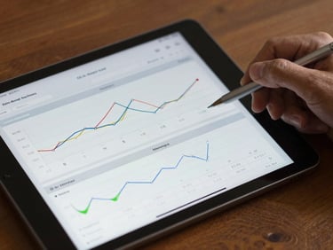 A close-up of a modern tablet displaying clear health charts, metabolic timelines, and biometric data visualizations in warm daylight.