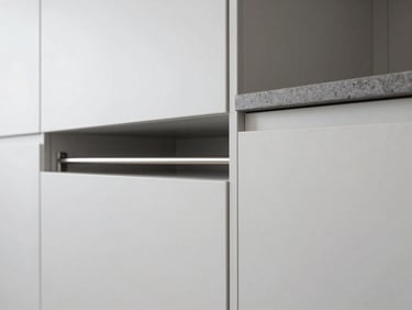 Modern kitchen cabinet installation with sleek hardware and a glimpse of a stainless steel railing, bright and clean, architectural detail.
