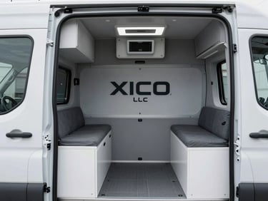 Clean, branded XICO LLC sprinter van interior, showing secure cargo tie-downs and climate control unit, bright warehouse lighting, cool desaturated tones.