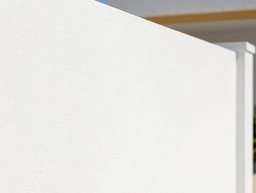 Close-up of a perfectly smooth, freshly painted white wall in natural Florida daylight, crisp details.