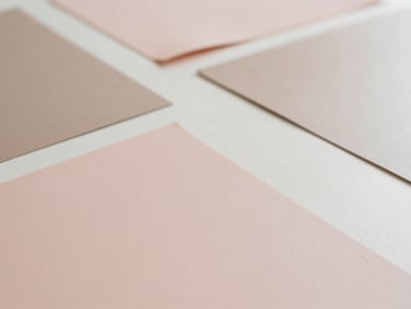 Flat lay of various matte vinyl sheets in blush and taupe with a clean Cricut mat, soft diffused daylight, organized, shallow depth of field.