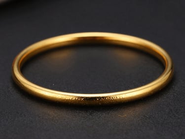 Macro close-up of a hand-beaten 22-karat gold bangle, sharp directional studio lighting, deep shadows, sparkling specular highlights against an obsidian background