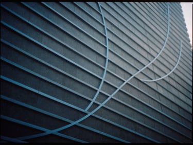 Abstract geometric pattern representing data flow, blue lines on dark background, sharp focus, 35mm film
