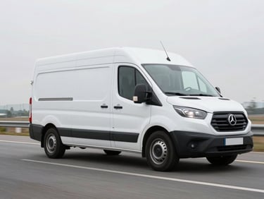 Dynamic low-angle shot of a clean white delivery van driving on an open road, bright overcast daylight, sharp focus, professional commercial photography.