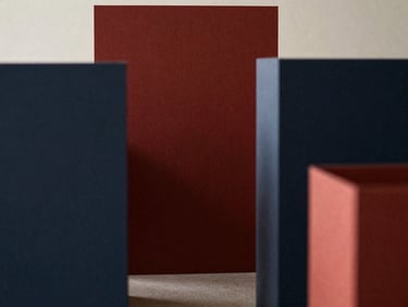Abstract structural details of a minimalist architectural model, muted crimson accents, low contrast, soft north-facing daylight.