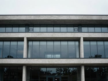 Modern public library or civic building with clean concrete and glass facade, overcast daylight, desaturated cool tones, 35mm