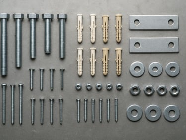 Overhead flat-lay of organized hardware supplies — bolts, anchors, brackets, and fasteners arranged by size on a steel surface, bright even fluorescent lighting, sharp product detail, no people
