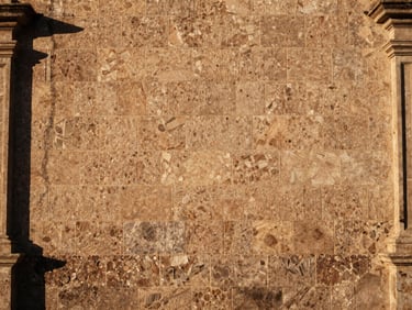 Traditional sillar stone wall of a heritage building in Monterrey, warm golden hour sunlight, architectural detail, 35mm.