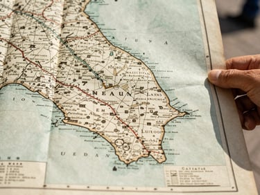 Close up of a hand holding an old historical map of Nuevo Leon, warm natural daylight, soft shadows, documentary feel.