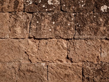 Close up of historic sillar stone wall, warm natural sunlight, architectural details of northeastern Mexico, 35mm documentary photography
