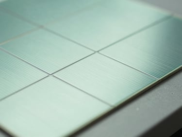 Close-up macro shot of silicon solar cells, geometric grid patterns, clean studio lighting, desaturated mint tones.