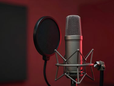 Close-up of a high-end condenser microphone in a vocal booth, with a pop filter, dramatic red backlight, cinematic studio photography.