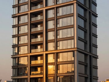 Warm twilight architectural elevation of DLF The Camellias, Gurugram, modern glass facade reflecting sunset, luxury residential design, high contrast, golden hour