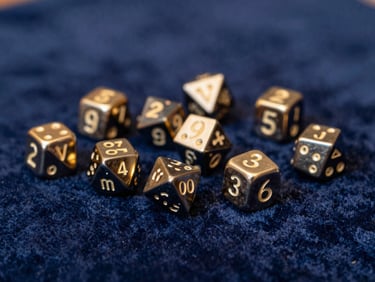 A selection of custom-forged metal dice, highly detailed, resting on a velvet cloth, with a soft glow reflecting off their surfaces, deep blue and gold tones, shallow depth of field.