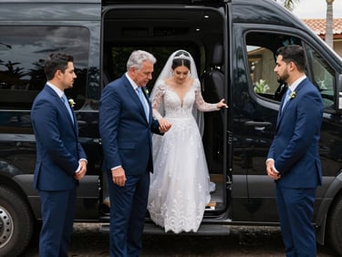Group of wedding guests boarding a white van at a resort entrance, golden hour light, bride's dress visible at the van door, natural and unposed moment, coastal vegetation in background