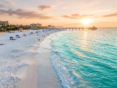 Vibrant coastal photography of Clearwater Beach at golden hour, wide-angle lens, turquoise water meeting pristine white sand, editorial style