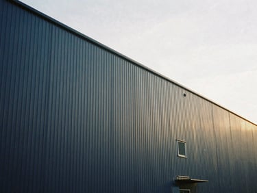 Architectural detail of a modern industrial distribution center, clean lines, soft natural overcast daylight, editorial style