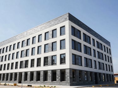 Wide-angle view of a modern commercial building under construction, clean lines, bright natural Alberta daylight, high-contrast, 35mm lens.