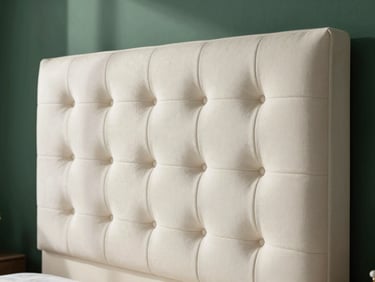 Close-up of a custom tufted headboard in textured ivory white fabric, clean lines, architectural shadow, 35mm