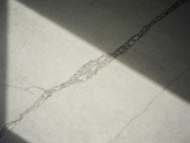Polished white marble slab with dramatic grey veins, architectural lighting